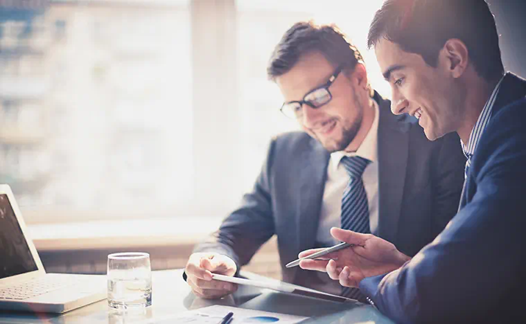 Two business men looking over a report.