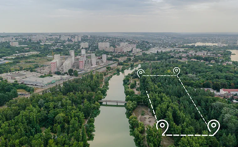 A skyline photo of a city with an outlined parcel along water.