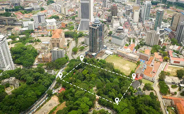 A birds eye view of a large city with a parcel outlined in white dots.