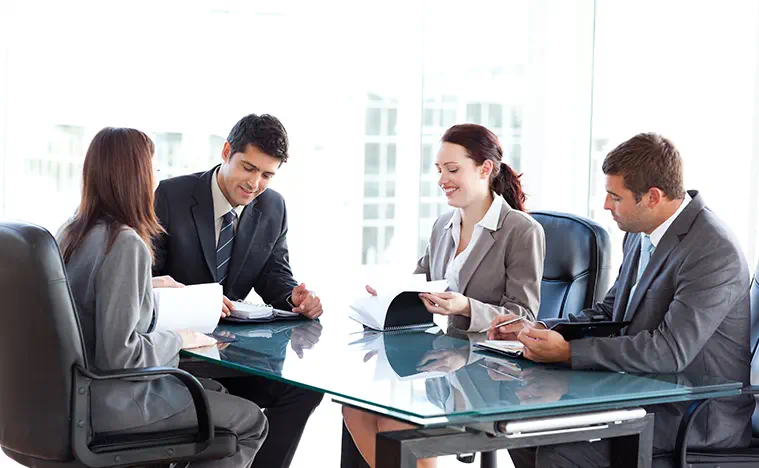 A group of business people meeting in a conference room.