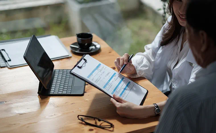 Two business people going over forms.