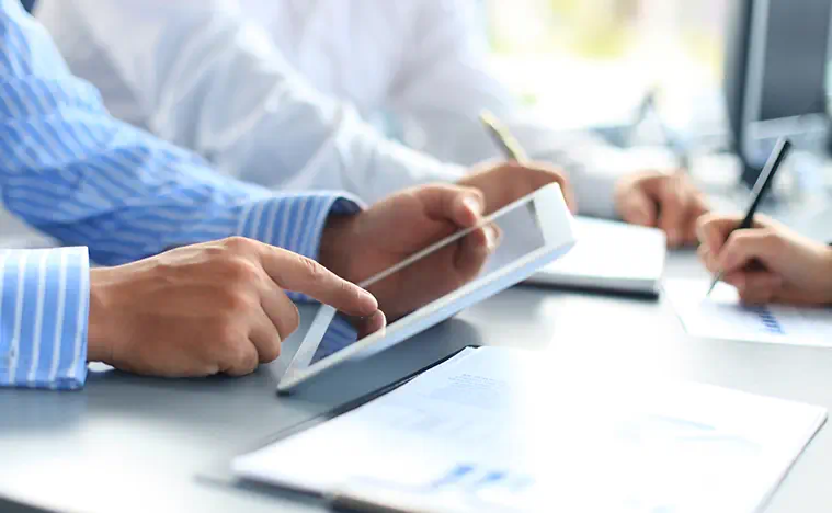 Close up of two business professionals looking at a tablet together.